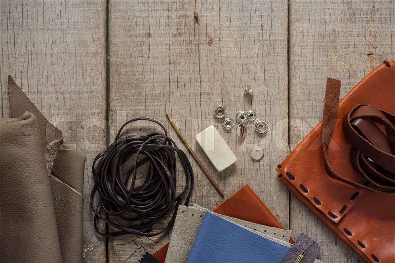 Repair equipment and leather on wooden floor, stock photo