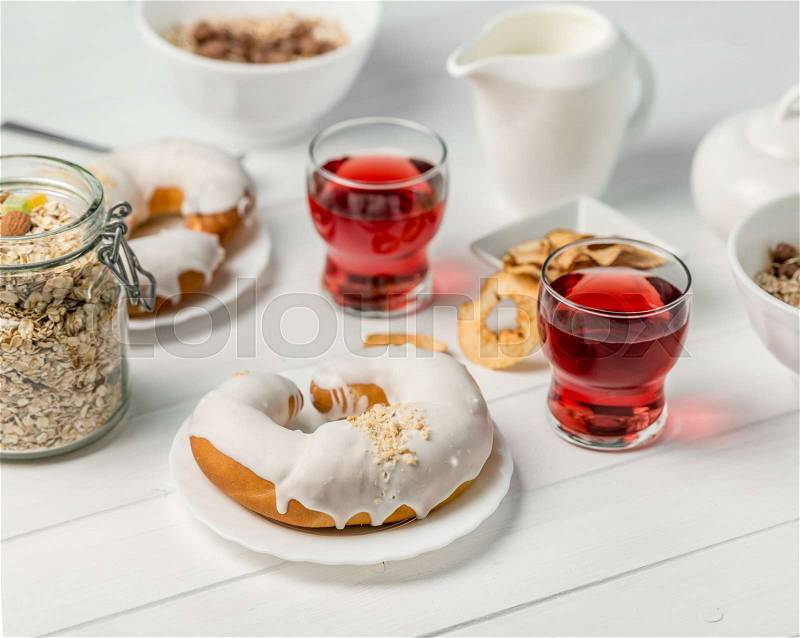 Luxurious breakfast with oats, apple chips, glazed croissant with chocolate and juice, milk on side, stock photo