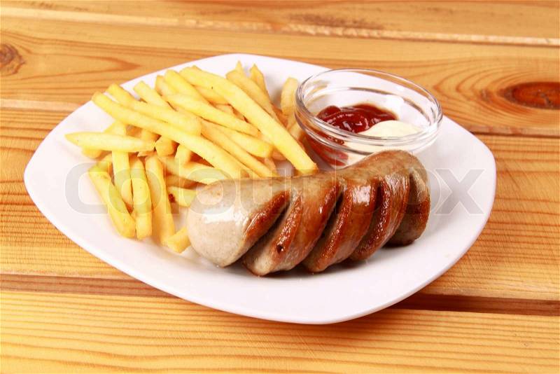 Grilled sausages with French fries and ketchup, stock photo