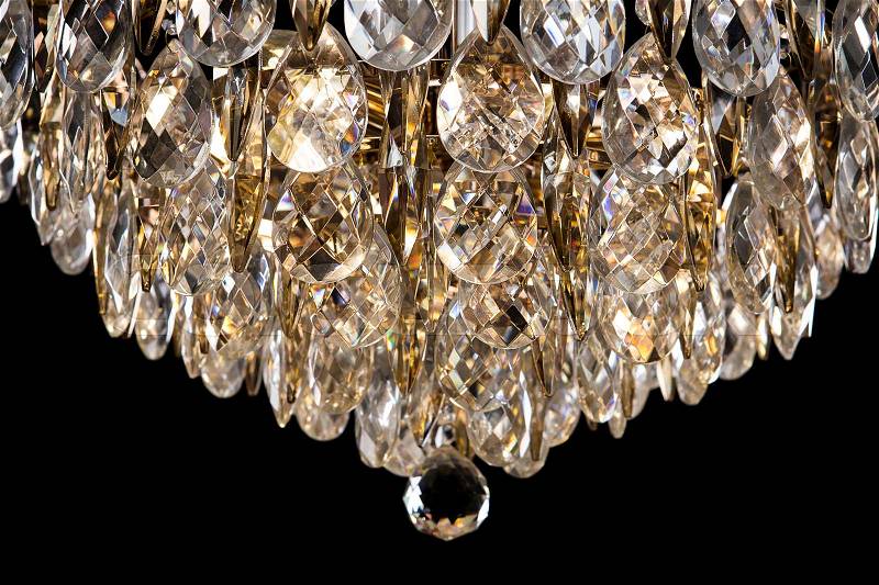 Large crystal chandelier detail isolated on black background. Luxury expensive chandelier for living room, Hall of celebration. Beautiful crystal decoration for the party, stock photo