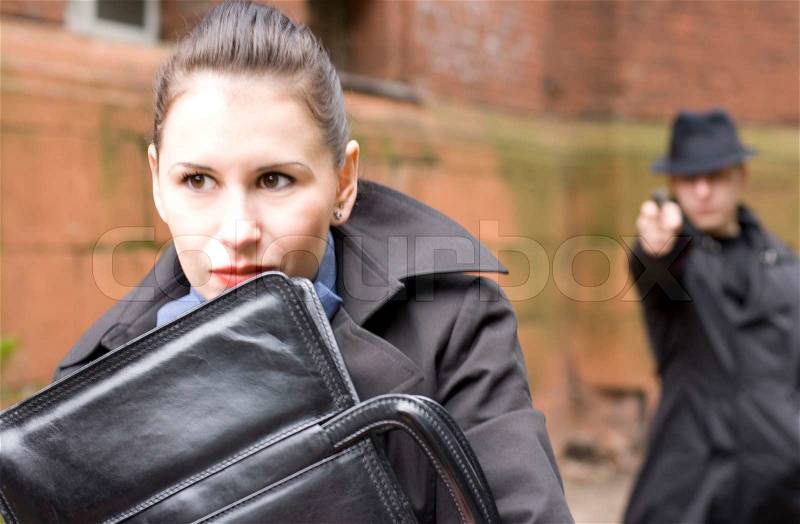 Man threatens the woman with a pistol, stock photo