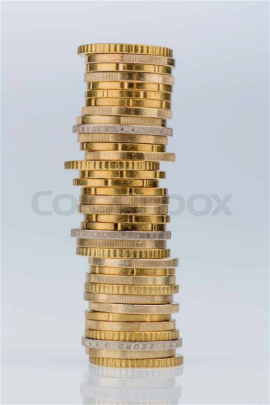 Stack of money coins against white background, symbol photo for saving, thrift, small savers, stock photo