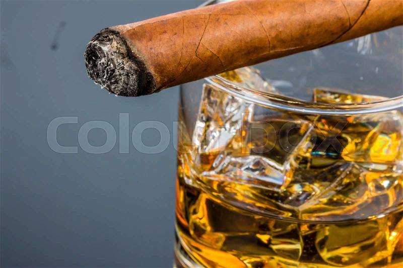 Cigar and whiskey. a symbol photo for addiction and pleasure, stock photo