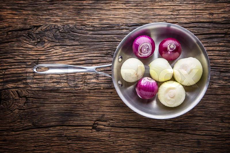 Onion. Red and white onions in pan on wooden board, stock photo