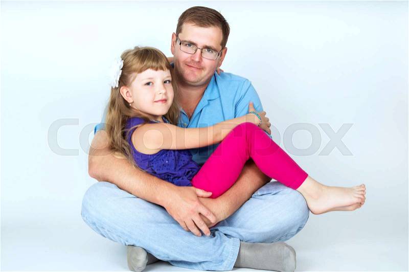 Dad hugs his daughter to, stock photo