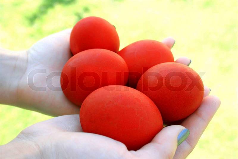Easter red eggs on the hand, stock photo