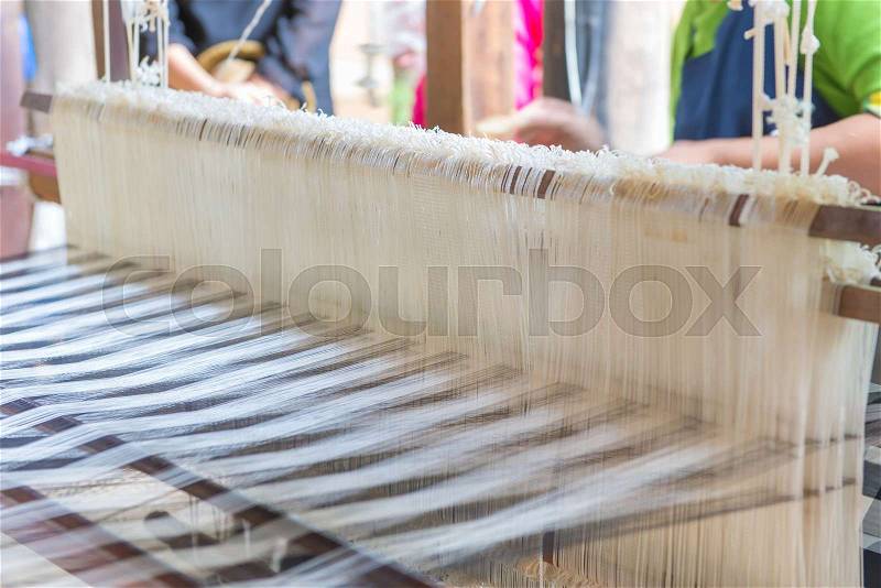 Weaving loom and shuttle on the warp, stock photo