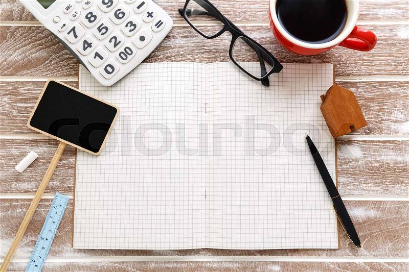 Blank notebook with house for sale sign and calculator for property taxes and mortgage concept, stock photo