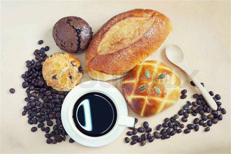 Cup of espresso coffee and many fresh baked breads on white shabby chic background. French breakfast. Top View, stock photo