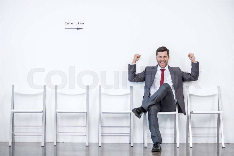 Excited businessman sitting and waiting for interview in office, business concept , stock photo