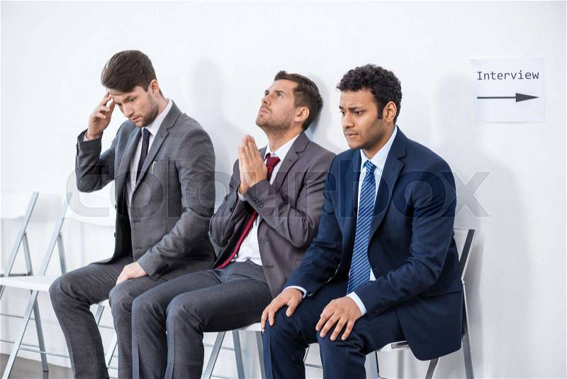 Businessmen sitting in queue and waiting for interview in office, business concept, stock photo