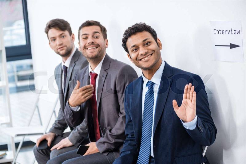 Businessmen sitting in queue and waiting for interview in office, business concept, stock photo