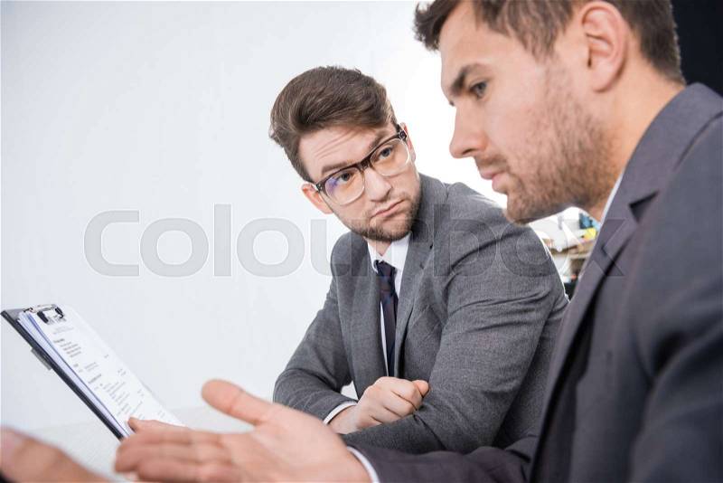 Side view of successful businessmen discussing job interview contender, stock photo