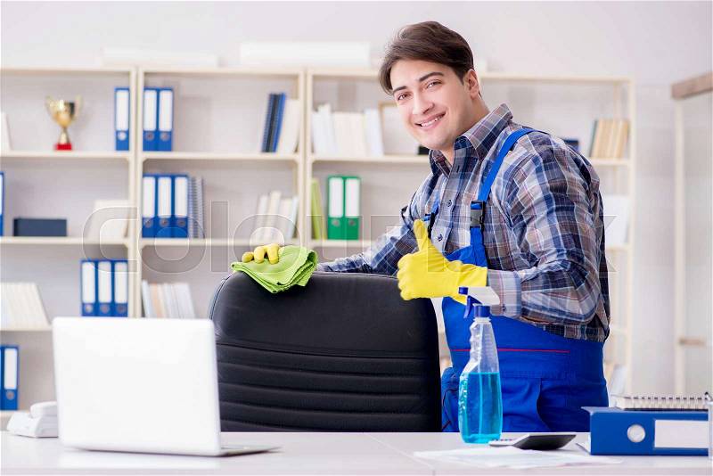 Male cleaner working in the office, stock photo
