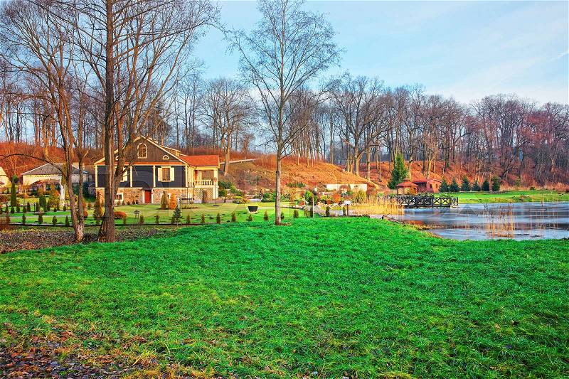 Old house and the pond in Belmontas, Pavilniai regional park near Vilnius, Lithuania, stock photo