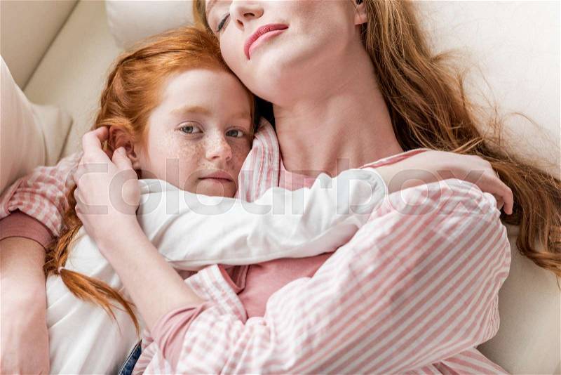 Sensual mother and little daughter hugging each other, stock photo