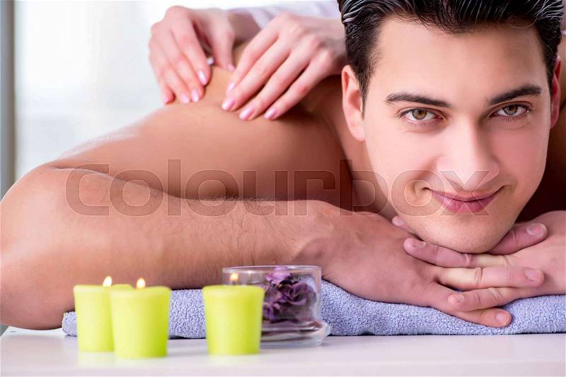 Handsome man in spa massage concept, stock photo