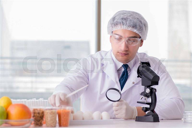 Nutrition expert testing food products in lab, stock photo