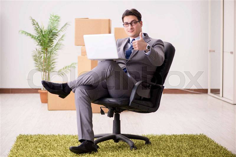 Businessman sitting on the chair in office, stock photo