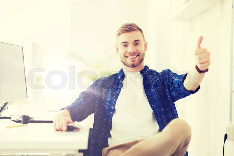 Business, technology, education and people concept - happy young creative man or student with computer at office at office showing thumbs up, stock photo