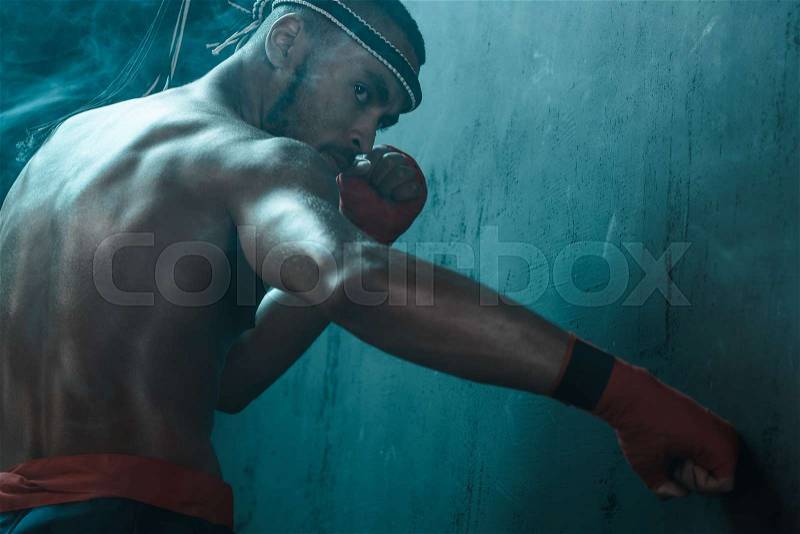Muay Thai athlete training at Thai boxing indoors, ultimate fight concept, stock photo