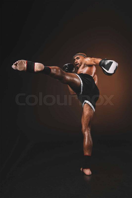Side view of muay thai fighter practicing kick, action sport concept , stock photo