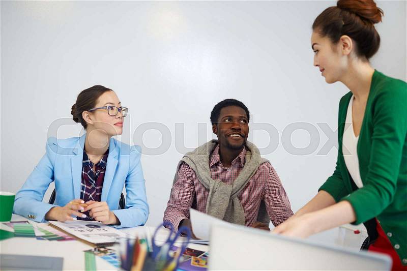 Two managers listening to their leaer while discussing ideas, stock photo