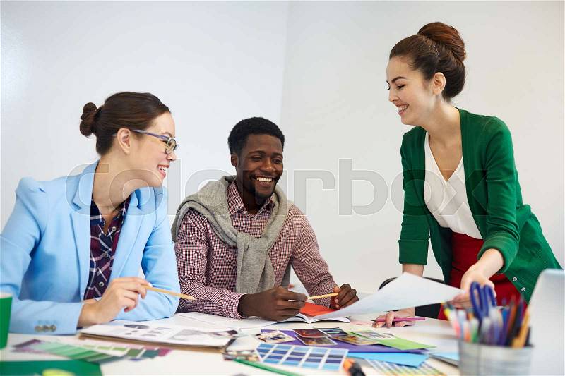 Brainstorming designers finding out and discussing new ideas for creative project, stock photo