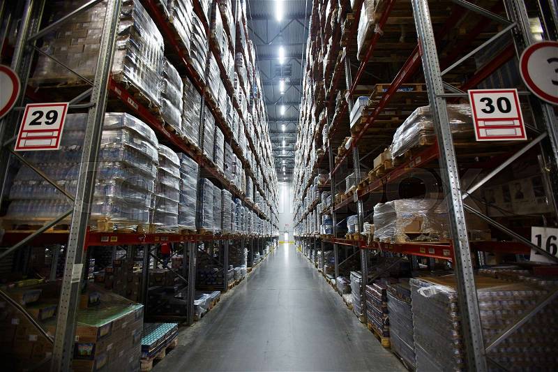 Aisle in warehouse between shelves with goods, stock photo