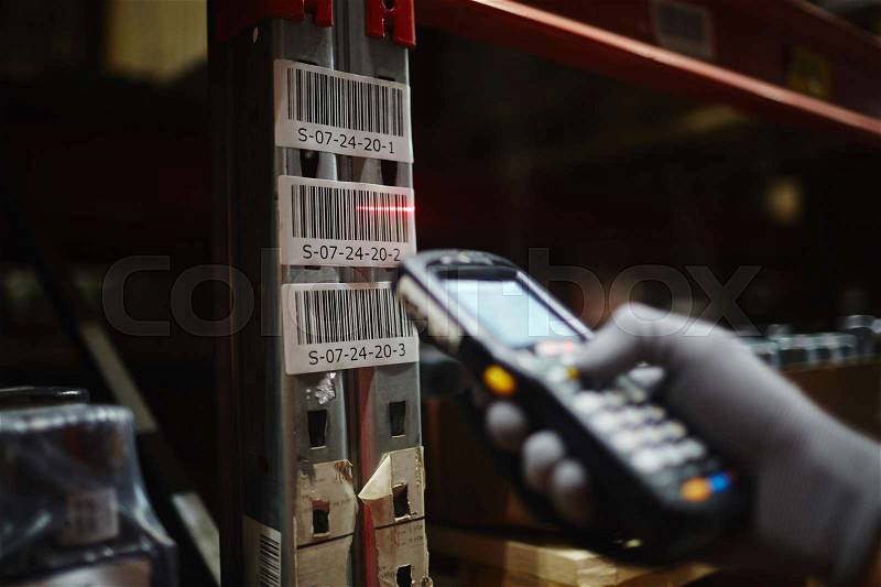 Scanner machine reading barcode on box with goods, stock photo