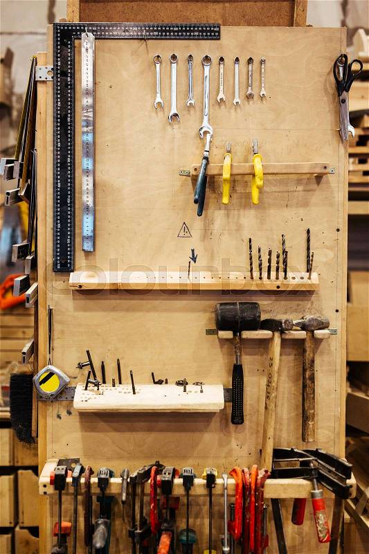 Background image of different woodworking tools on stand in carpenters workshop studio, stock photo