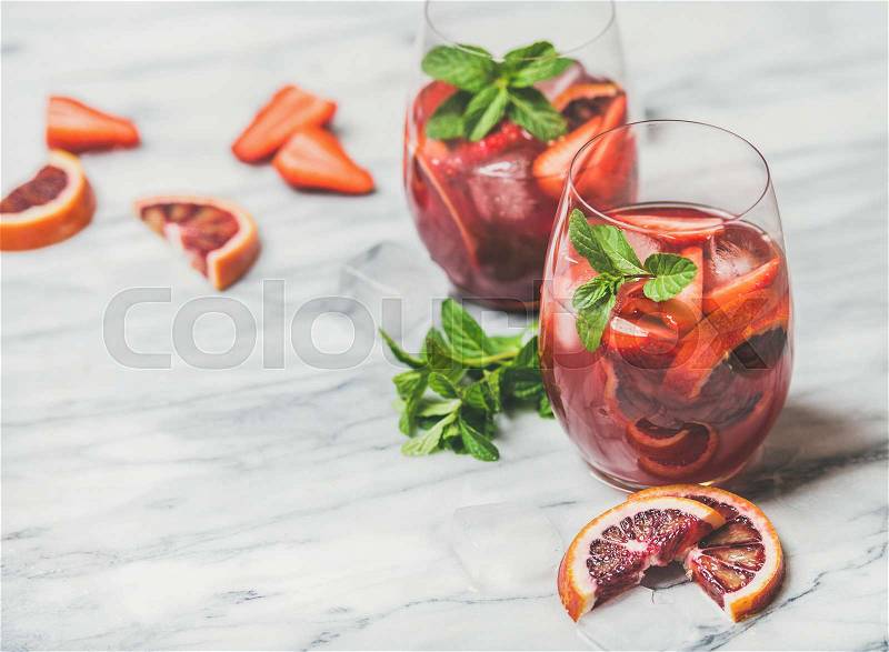 Fruit refreshing Sangria cocktails with ice cubes and fresh mint, stock photo