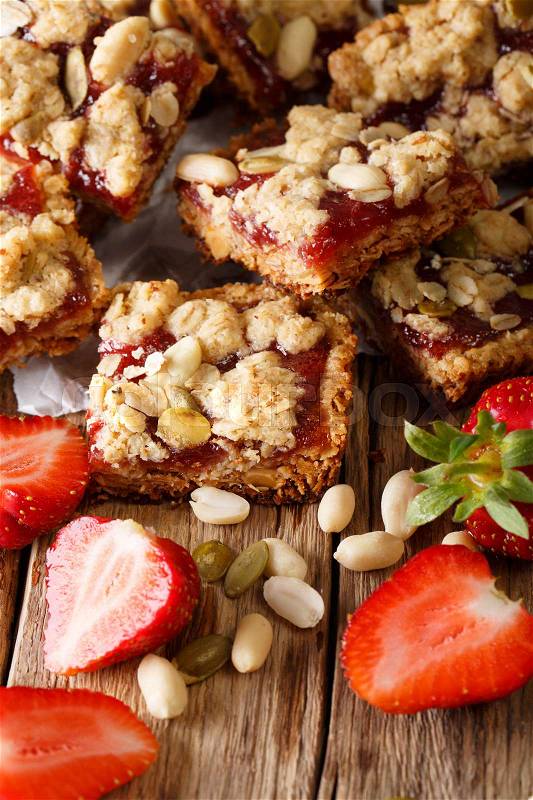 Peanut and Strawberry Jelly Oat Bar Squares close-up on the table. Vertical , stock photo