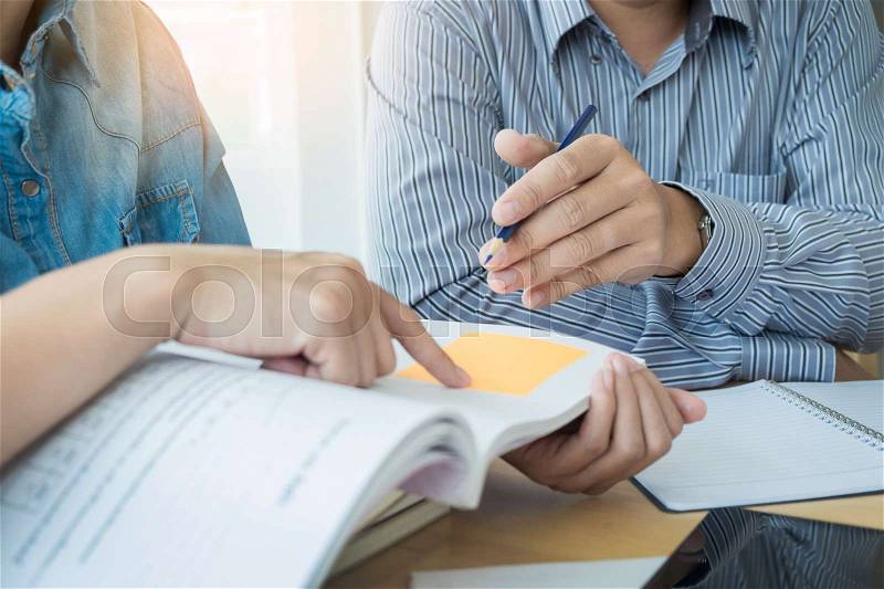 Young students campus helps friend catching up and learning tutoring. People, learning, education and school concept, stock photo
