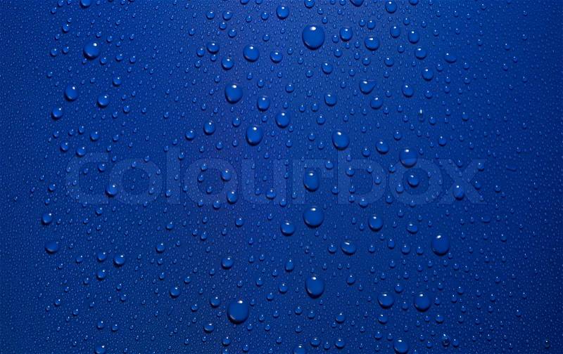 Studio photography of roll-off water drops in blue back, stock photo