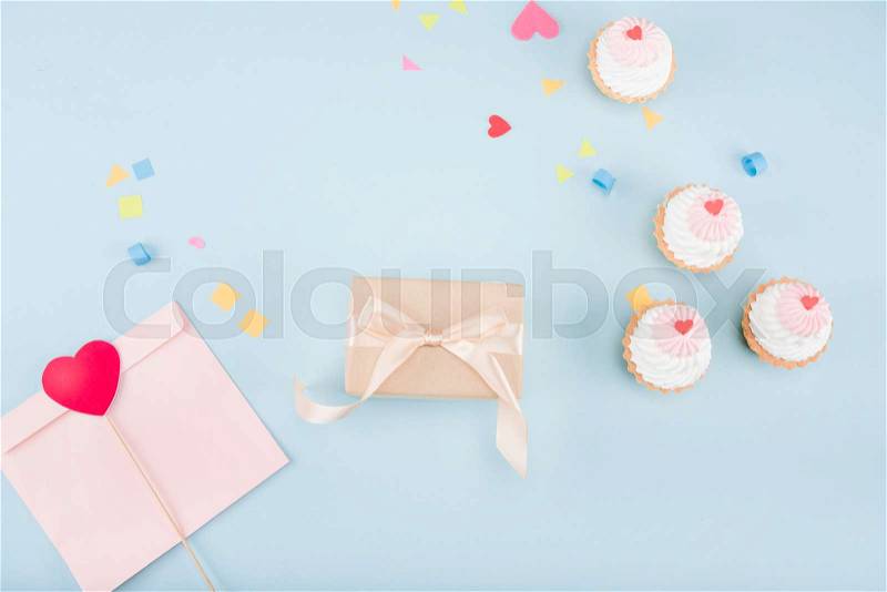 Top view of cakes and gift box with ribbon mock-up, birthday party, stock photo