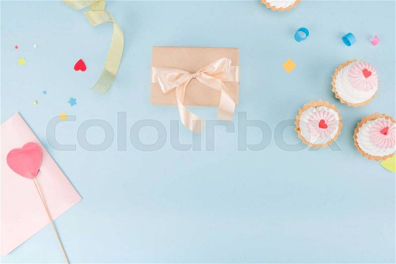 Top view of cakes and gift box with ribbons mock-up, birthday party, stock photo