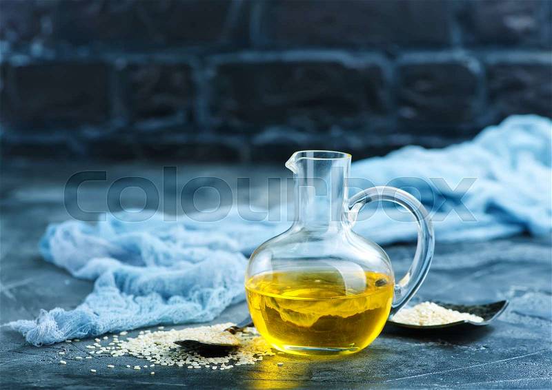 White sesame and oil in glass bottle, stock photo