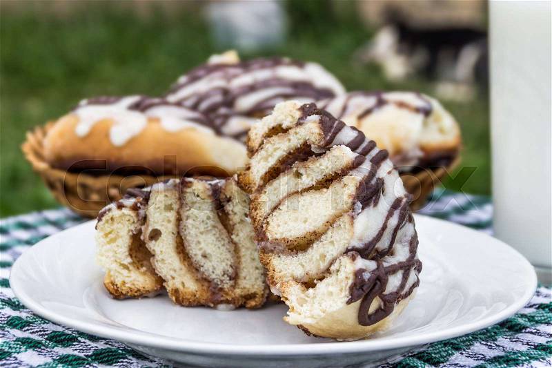 Homemade cinnabons cinnamon buns with cream cheese glaze and chocolate icing, stock photo