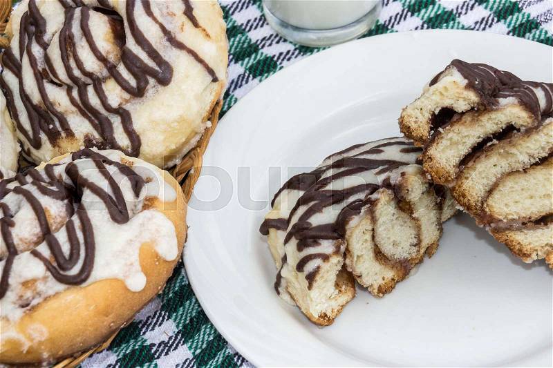 Homemade cinnabon cinnamon buns with cream cheese glaze and chocolate icing, stock photo