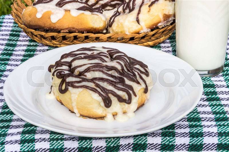 Homemade cinnabons cinnamon buns with cream cheese glaze and chocolate icing, stock photo