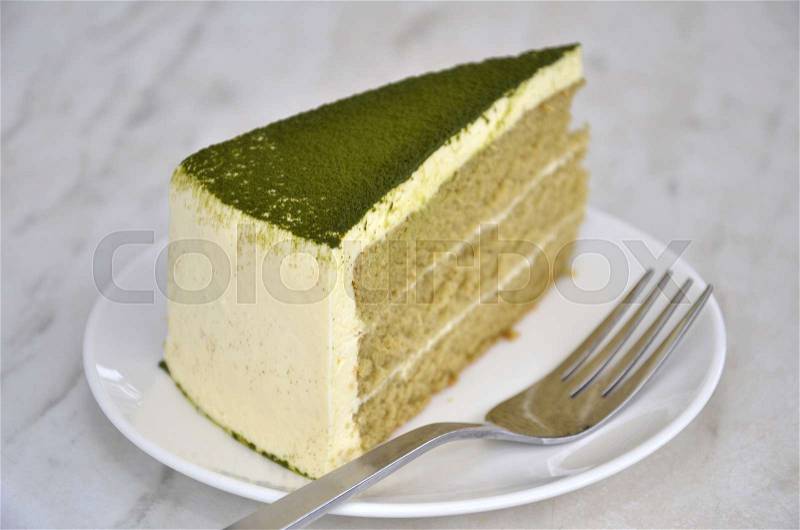 Green tea cake on table with fork, stock photo