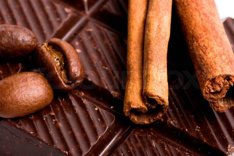 Arrangement of chocolate, coffee and cinnamon sticks, stock photo