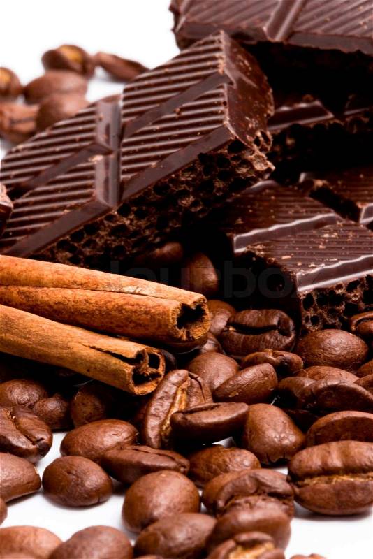 Arrangement of chocolate, coffee and cinnamon sticks on white, stock photo