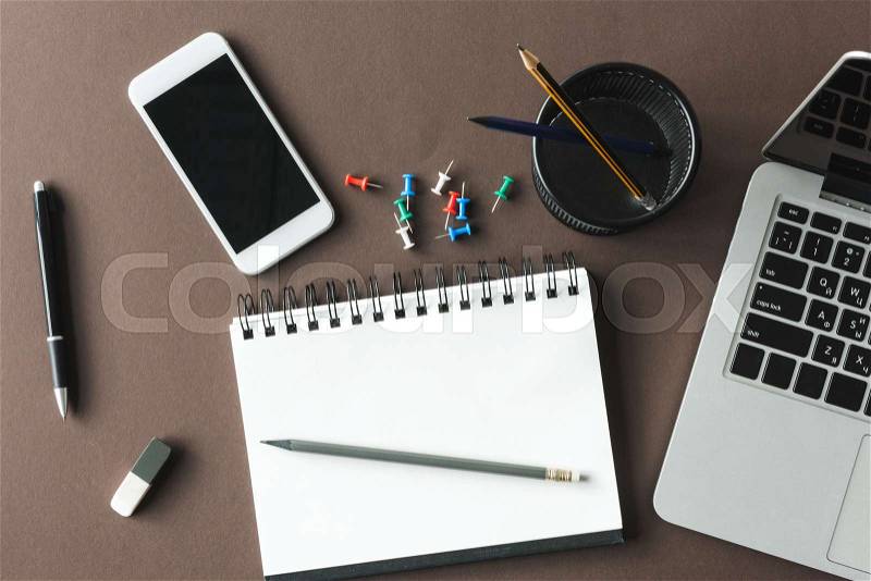 Top view of laptop, empty notebook and smartphone with blank screen at workplace, small office concept, stock photo