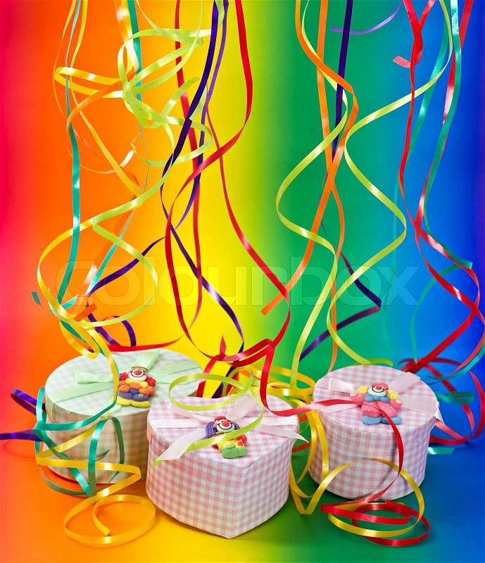 Gifts on colorful background with party streamer, stock photo