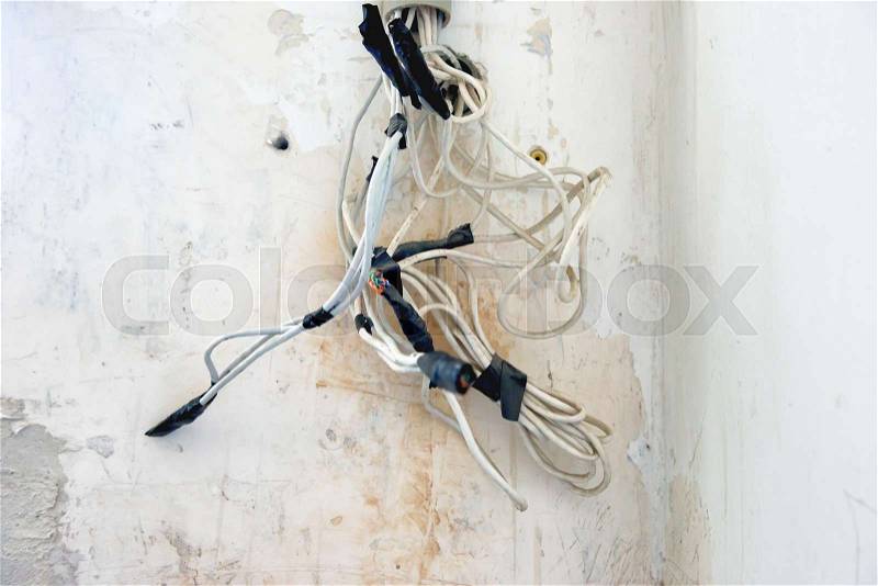 Mess of power cables on the wall, stock photo