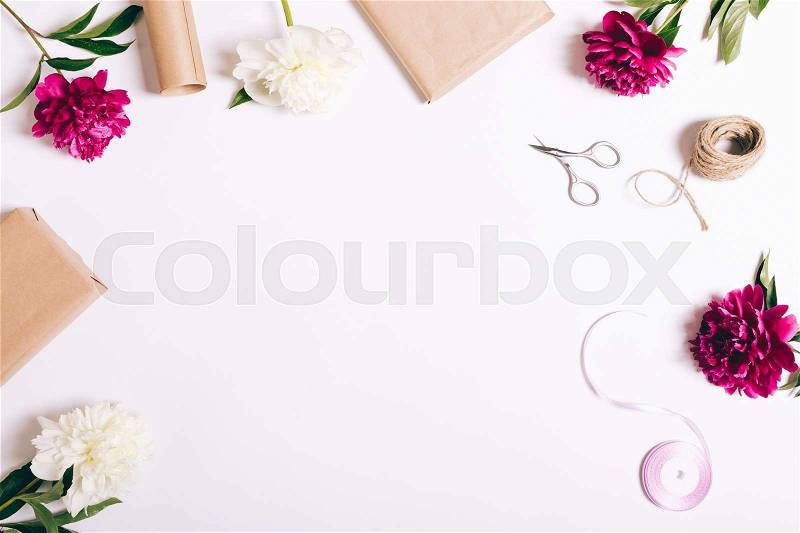 Festive composition of flowers and gifts on a white table, top view, stock photo