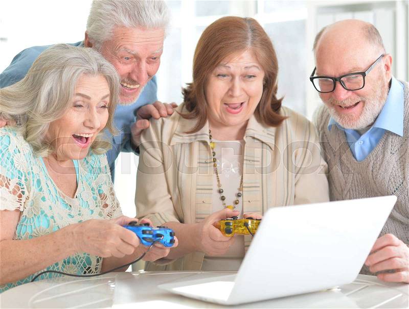 Old people playing board games at home, stock photo