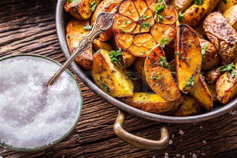 American potatoes. Baked potatoes in peel. Roasted potatoes with garlic spices salt cumin and herbs, stock photo